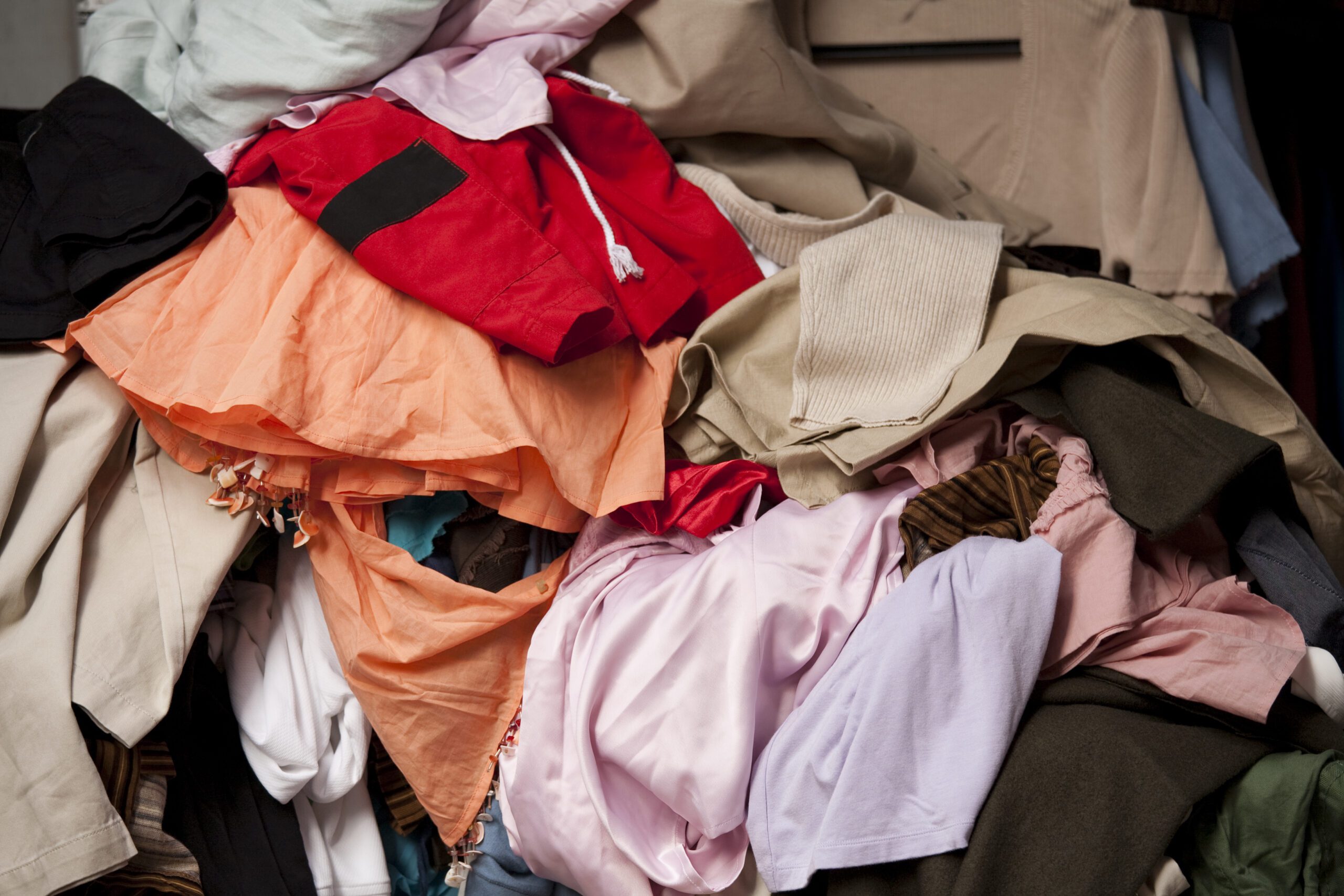 Jumble of clothing at a flea market or garage sale.